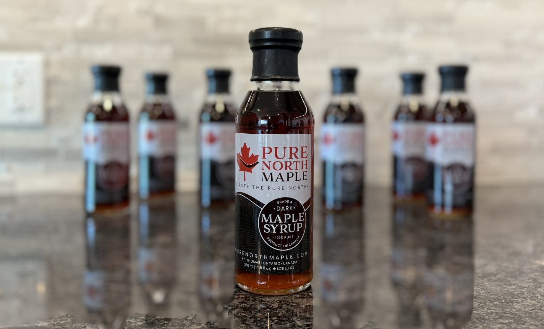 Pure North Maple bottle photographed with natural bottles and background