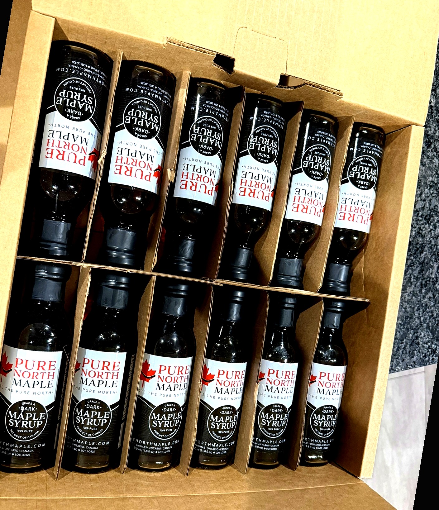Open case of Pure North Maple bottles for wholesale